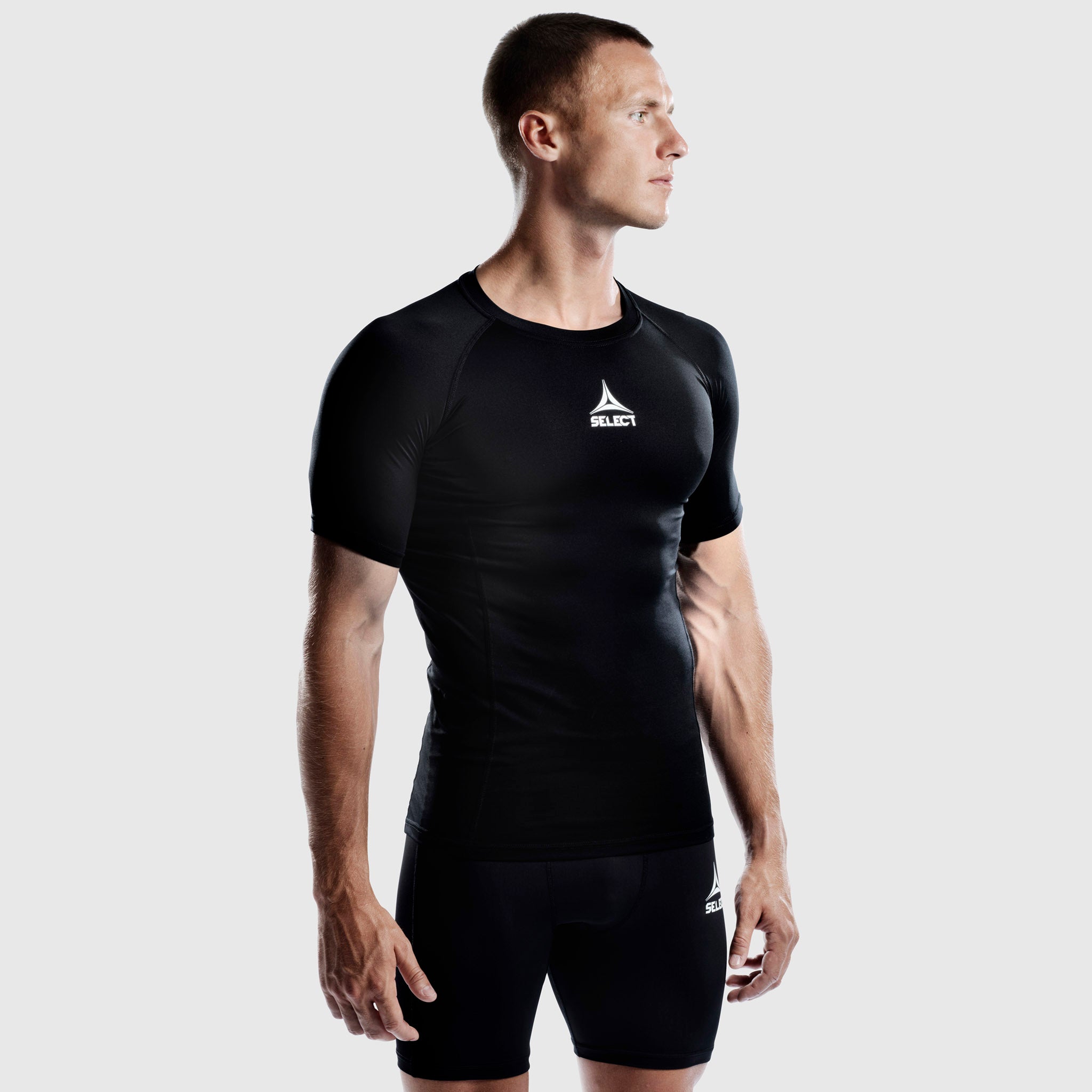 Manlig fotbollsspelare i svart Shirt S/S Baselayer, framifrån